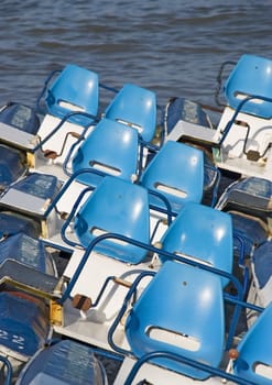 Catamarans combined on coast with brightly dark blue seats