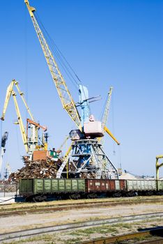The load-lifting crane. Loading of scrap metal in railway cars