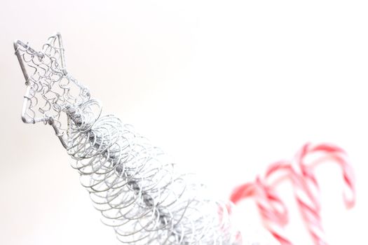 Christmas Tree and candy canes on white background.