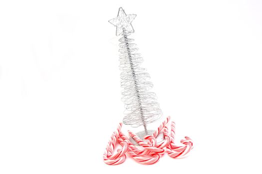 Christmas Tree and candy canes on white background.