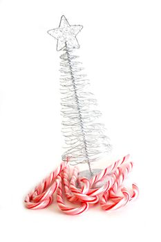 Christmas Tree and candy canes on white background.