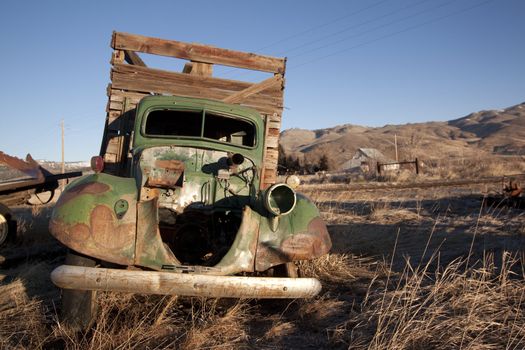 old rusty farm truck in the middle of a field