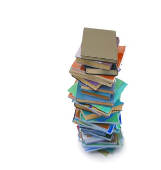 Stack of colorful real books on white background, partial view.