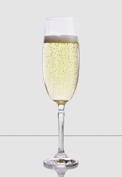 A glass of champagne, isolated on a white background.