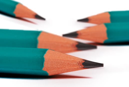 close up of green pencils isolated on white