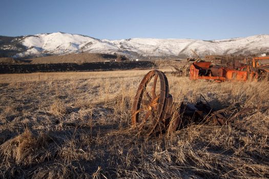 old rusty farm equipment in the middle of a field