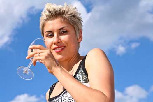 Cute blond girl playing with water in the summer in Denmark