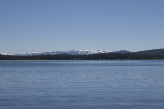 Empty lake with calm water surface in the mountains