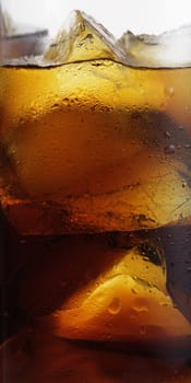 cola with ice cubes close up isolated