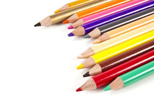 Color pencils in arrange in color wheel colors on white background with copy space