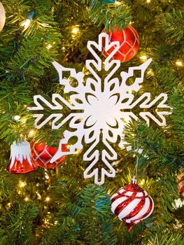 Red and White Christmas Ornaments on a Green Tree with White Lights