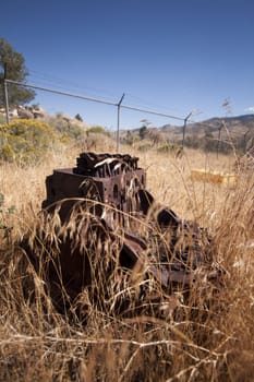 Old rusty engine block abandoned in the field.