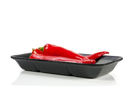 Fresh red hot pepper with black plate on a white background