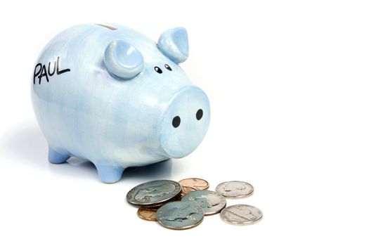 Blue piggy bank savings and coins on white isolated