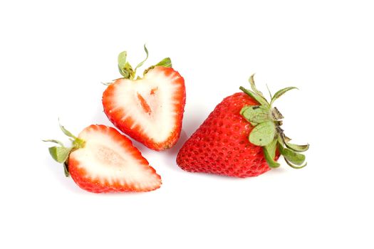 Fresh ripe red strawberries on white. The strawbery in front is sliced in half.