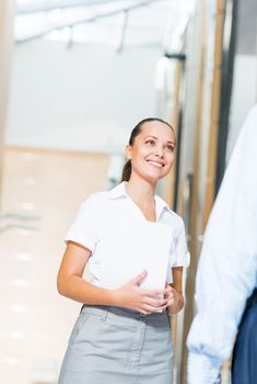 Business woman talking with a colleague in the office