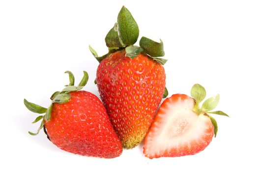 Image of two isolated strawberries, one of them is sliced in half.