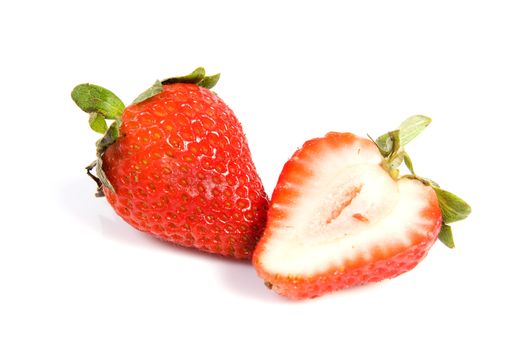 Fresh ripe red strawberries on white. The strawbery in front is sliced in half.