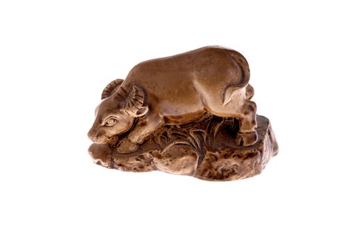 A small, brown, carved statue of an OX (one of the Chinese Zodiak animals). Also the western zodiak system for Taurus.