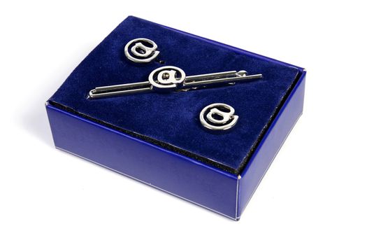 Tie clip and cufflinks formalwear accessory in the purple box