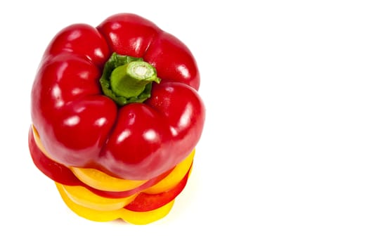 Slices of red and yellow sweet peppers stacked together on a white with blank text message copy space