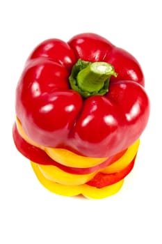 Slices of red and yellow sweet peppers stacked together on a white 