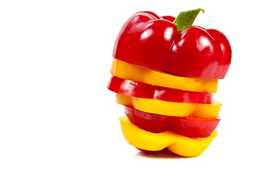Slices of red and yellow sweet peppers stacked together on a white with blank text message copy space