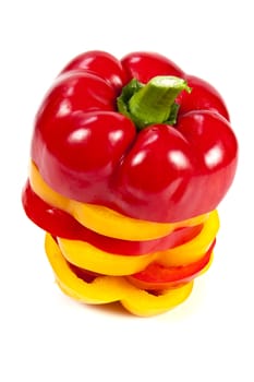 Slices of red and yellow sweet peppers stacked together on a white