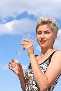 Cute blond girl playing with water in the summer in Denmark