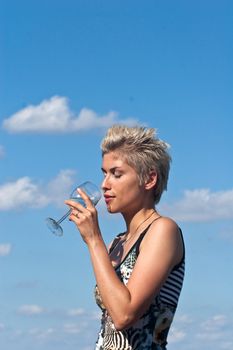 Cute blond girl playing with water in the summer in Denmark