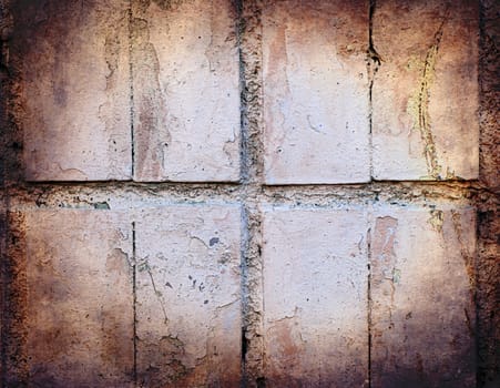 Grunge texture of pastel colour broken tiles on old wall