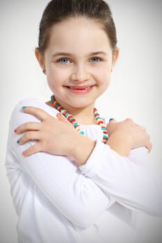 Portrait of smiling little girl with crossed arms