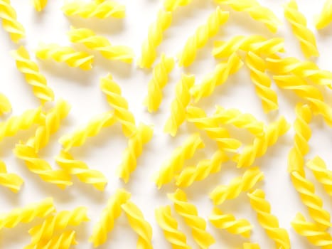 close up of fusilli pasta on white