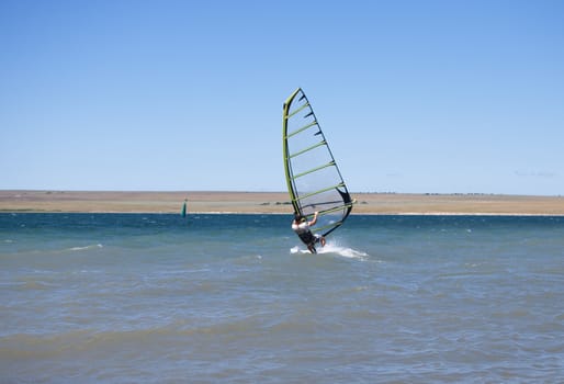 man windsurfing in a lake