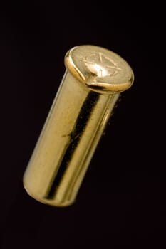 Dirty Used .22 LR shell casing on black