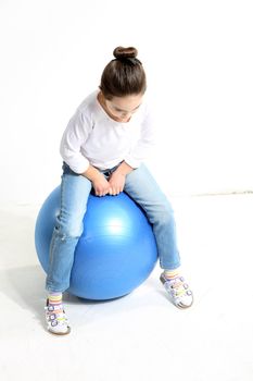 Little girl posing with a rubber ball