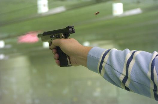 Right hand shooting a automatic pistol, casing and flame showing