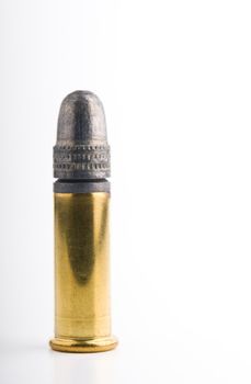 Single .22 lr rimfire cartridge against white