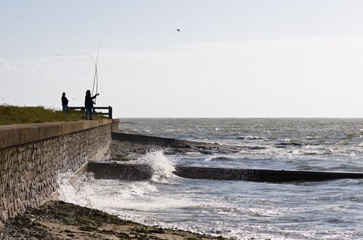 Fisherman throwing line on atlantic French coast