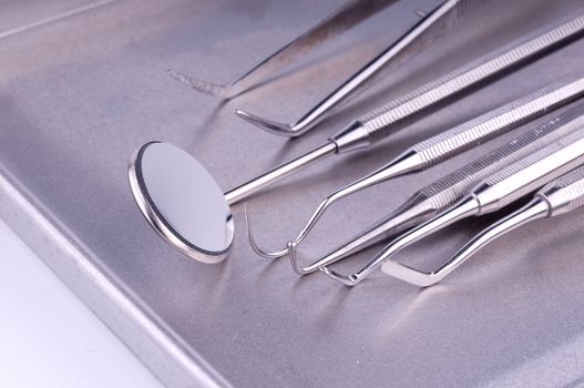 Dentist tools on metal tray