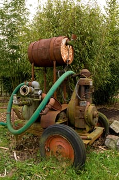 Old and rusty mobile water pump on a plantation