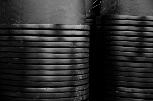 Piles of inverted black flower pots