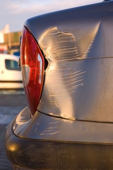 A dent in the right rear quarter of a european car 