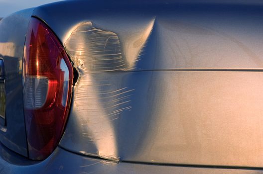 A dent in the right rear quarter of a european car 