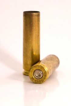 Two dirty .30 M1 Carbine shell casings