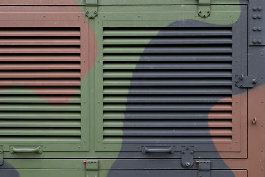 Ventilation grille on camouflaged aluminum army shelter