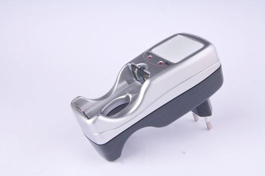 Small silver and gray plug-in battery charger