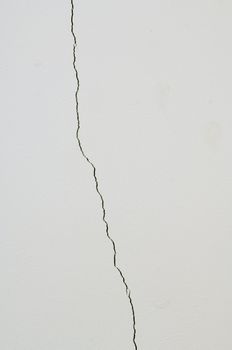 White wall with irregular vertical crack