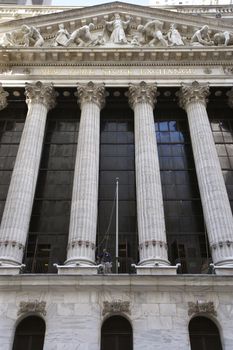 New York City, New York, USA - October 9, 2010: Exterior of the New York Stock Exchange building. An employee is working on the columns of the building. Low angle view. 