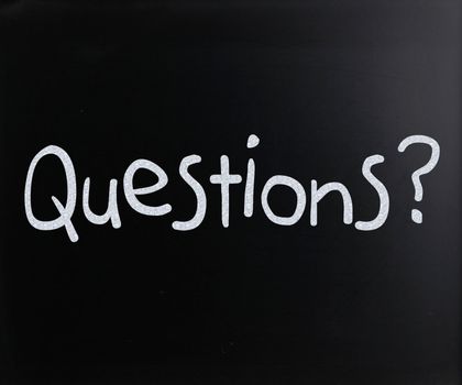 "Question" handwritten with white chalk on a blackboard